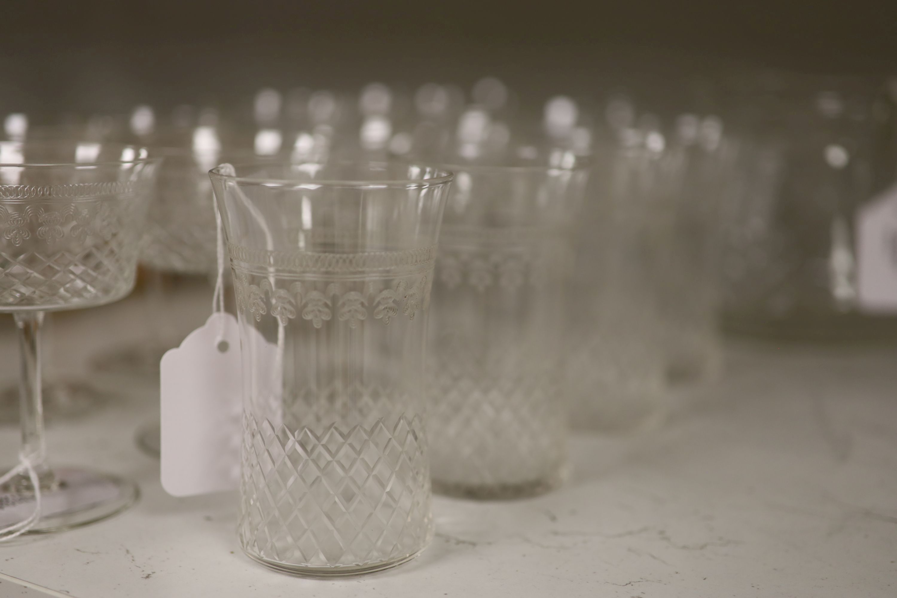 A part suite of 1930's table glass, comprising a water jug, four tumblers, six red wines and seven white wine glasses,